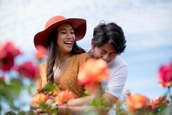 Couple cuddling in the rose garden